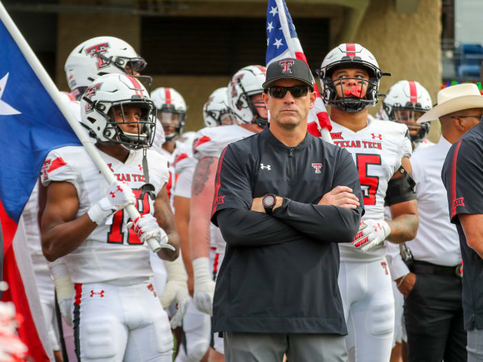 Texas Tech Red Raiders head coach Matt Wells leads his team onto the field prior to their game against the West Virginia Mountaineers at Mountaineer Field at Milan Puskar Stadium.